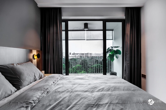 Contemporary master bedroom design with bedside sconces and wooden paneling for a cozy ambiance.