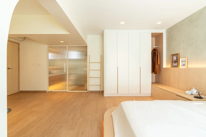 Modern master bedroom design featuring a built-in wardrobe with a clean, white finish.