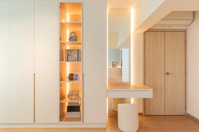 Sleek master bedroom design with a functional dressing table and warm lighting.