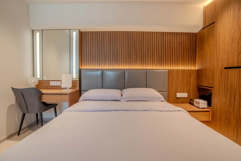 Minimalist master bedroom design featuring wooden tones and a clean, modern layout.