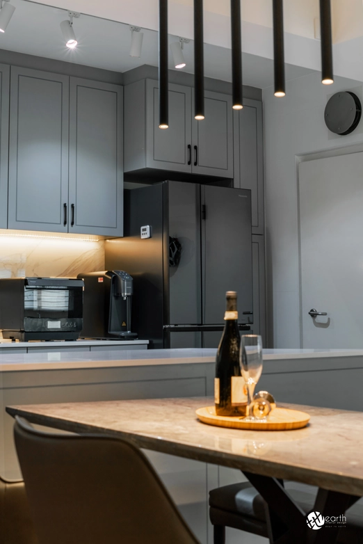 Modern kitchen featuring gray cabinets, warm under-cabinet lighting, and integrated appliances.