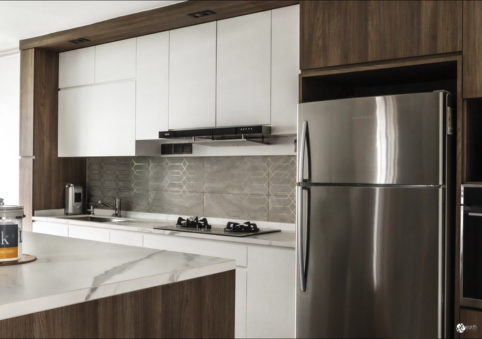 Compact kitchen featuring light wood cabinetry and built-in appliances for efficient use of space.