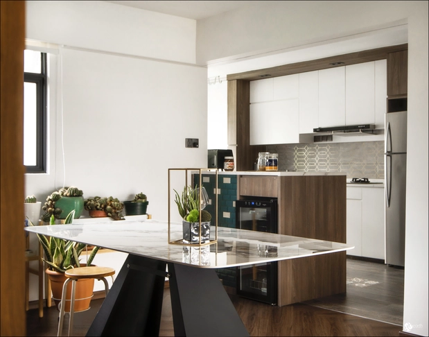 Small kitchen design with light wood cabinets and a sleek glass hood above the stove.