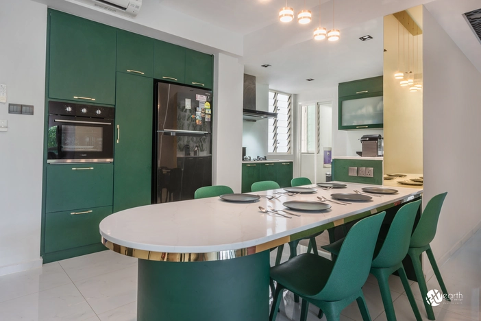 Bright kitchen featuring gold-accented furniture and green cabinetry.