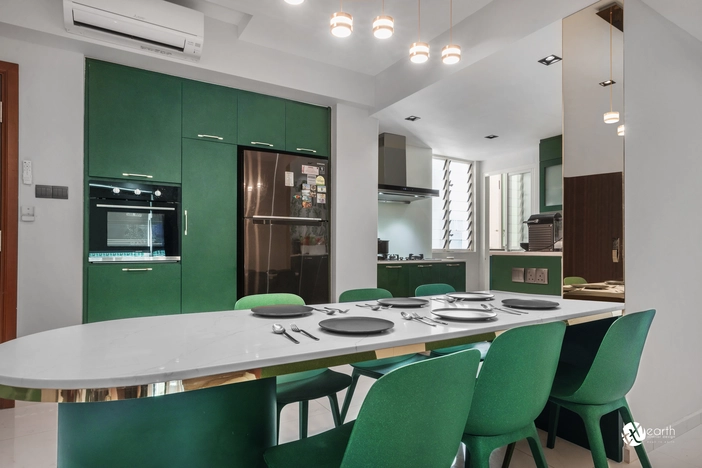 Elegant green-themed kitchen with modular cabinets and sleek lighting.