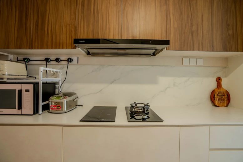 Functional wet kitchen design with custom cabinetry and a marble sink counter.