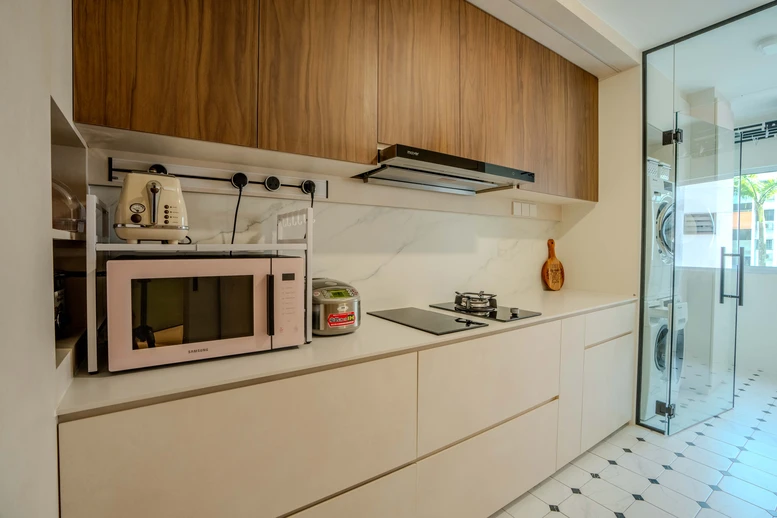 Compact kitchen with wooden cabinetry, marble backsplash, and integrated appliances.