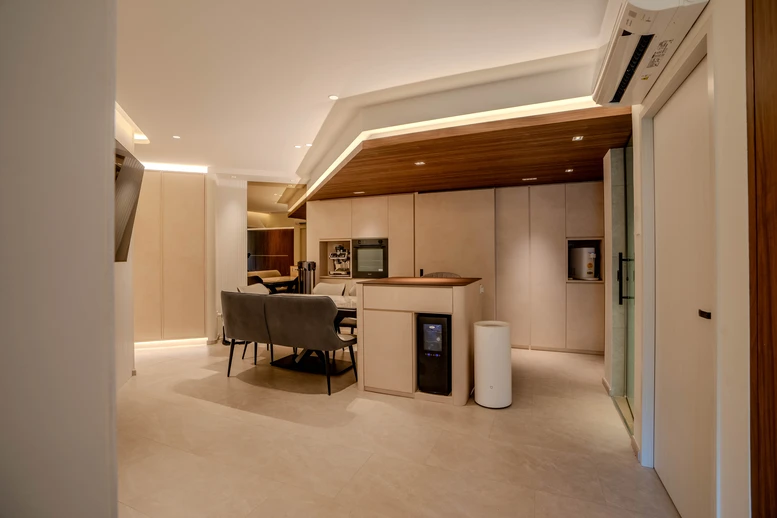 Open-concept kitchen and dining area with warm wooden accents and a minimalist layout.