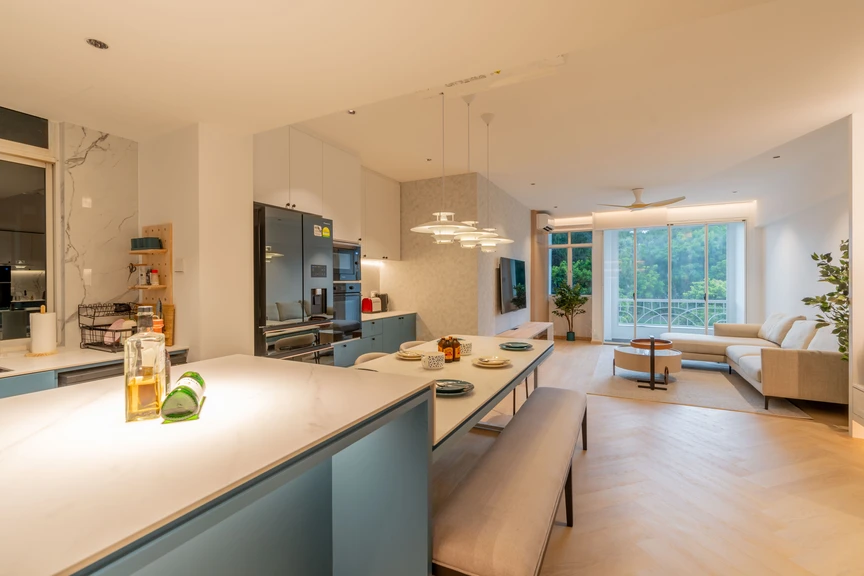 Spacious kitchen and dining area with clean white countertops, contemporary lighting, and seamless cabinetry.