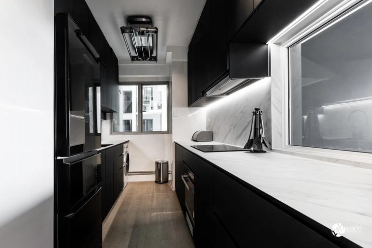 Compact kitchen with sleek black cabinetry and integrated lighting for a luxurious feel.