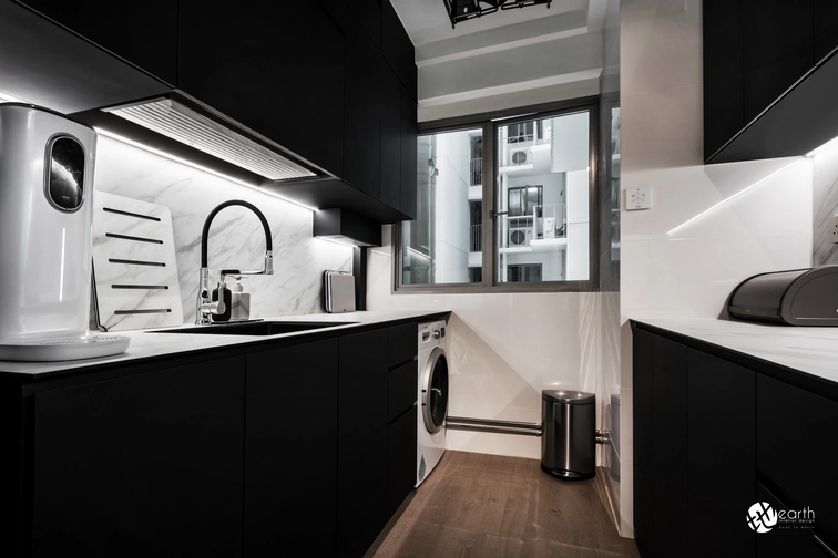 Modern small kitchen featuring black cabinets, a marble backsplash, and functional storage solutions.