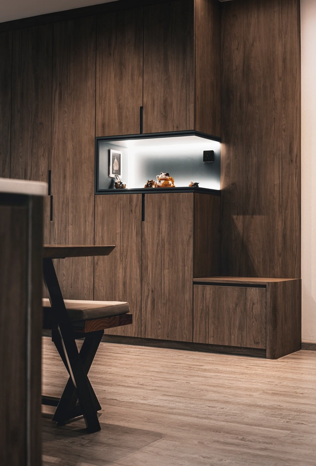 Built-in cabinet with display shelf, featuring dark wood tones and modern design aesthetics.