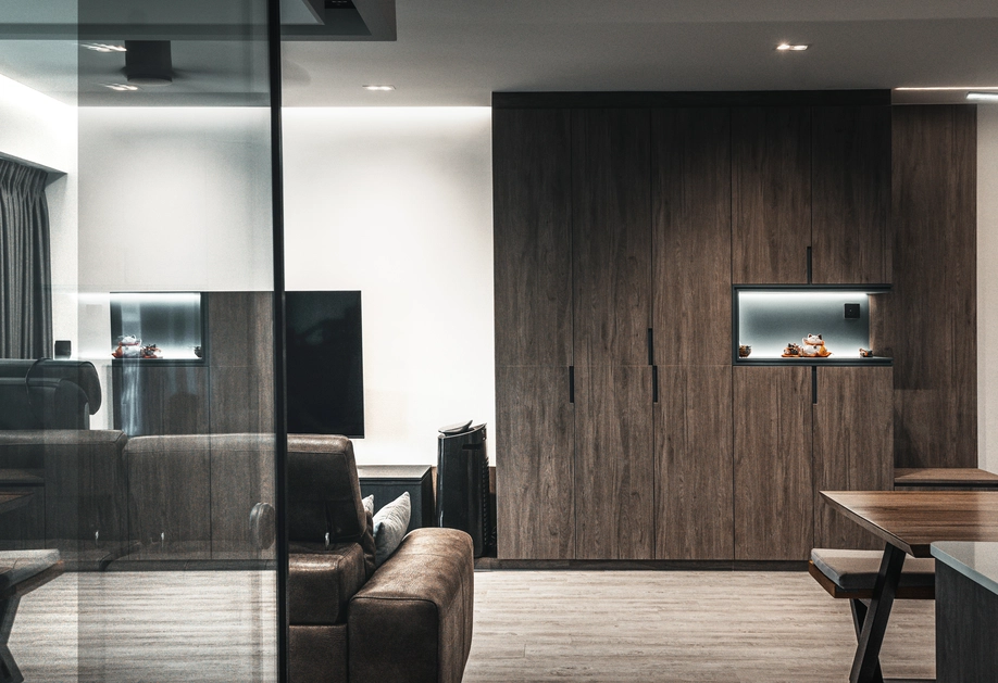 Full view of a living room with dark wood cabinetry and modern furnishings.