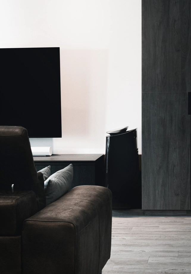 TV console setup with dark wood cabinetry and sleek, modern design in an HDB flat.