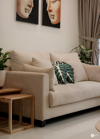 Neutral-toned sofa with green plant decor and natural textures for a calming atmosphere.