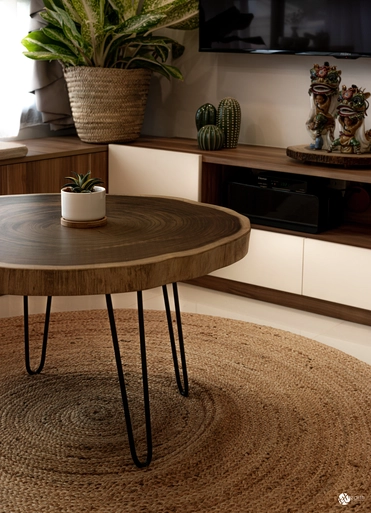 Cozy living room featuring a wooden coffee table, round woven rug, and natural plant decor.