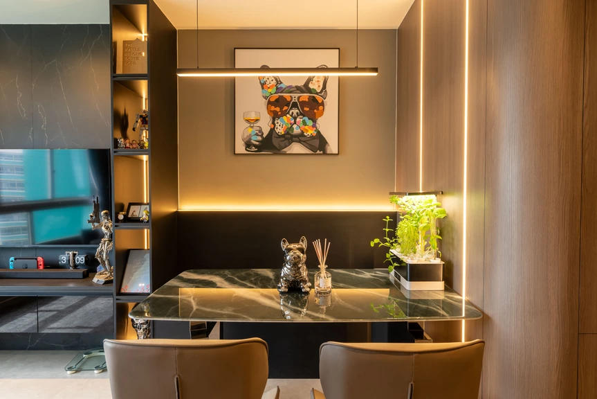 Stylish dining nook with artistic wall decor and a modern marble table in a Singapore home.