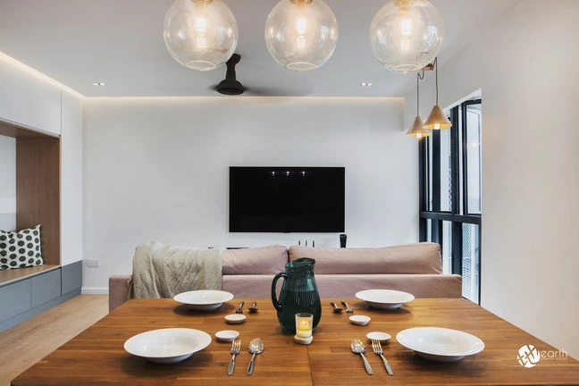 Contemporary dining setup with wooden table, modern pendant lights, and neutral tones.