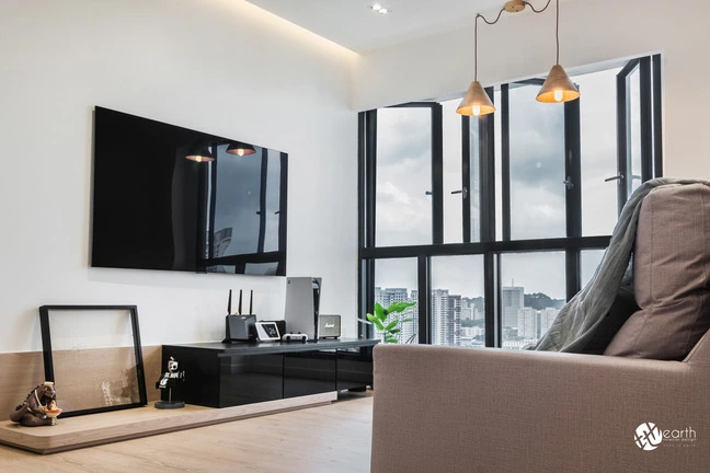 Minimalist living room design with a sleek TV feature wall and panoramic window views.