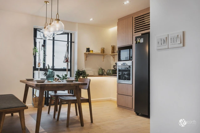 Open-concept kitchen and dining area with Scandinavian design elements and warm wood accents.